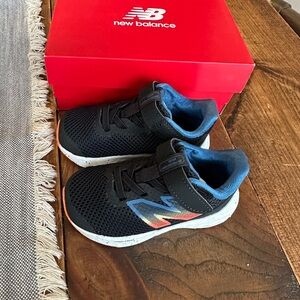 New Balance Black Kids Sneakers with Blue and Orange Gradient Logo